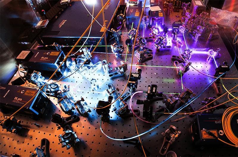 Quantum Research UMD, Lasers in various colors bouncing between mirrors setup on an experiment table