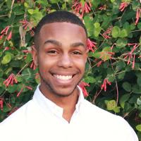 Myles Alexander on a background of green and flowering Ivy